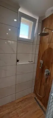 a bathroom with a shower with a window and a sink at Black Sea View - Luxory apartment by the sea in Burgas City
