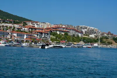 a group of boats docked in a harbor with buildings at OLYMP Apart-Complex in Sveti Vlas