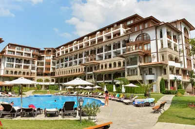a hotel with a pool in front of a building at OLYMP Apart-Complex in Sveti Vlas