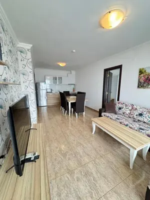 a living room with a couch and a table at OLYMP Apart-Complex in Sveti Vlas