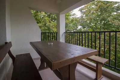 a wooden table and a chair on a balcony at к-г Луна к-с Лонгоза комплекс Лонгоза in Byala