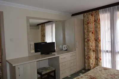 a bedroom with a desk with a computer on it at Hotel Morska Zvezda in Sozopol