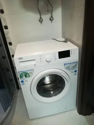 a washing machine in a bathroom with a washing machine at Апартамент Дарко in Pomorie