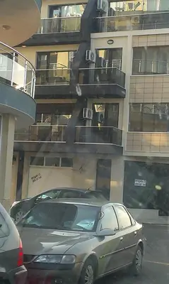 a car parked in front of a building at Апартамент Дарко in Pomorie