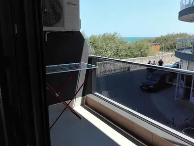 a balcony with a window with a view of a patio at Апартамент Дарко in Pomorie