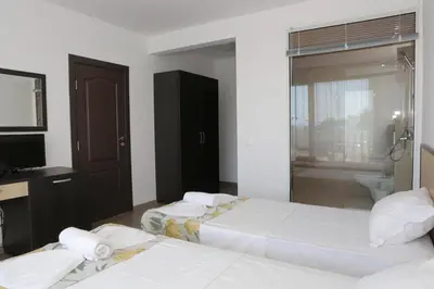 a hotel room with two beds and a television at St. Stefan Villas & Hotel in Sozopol