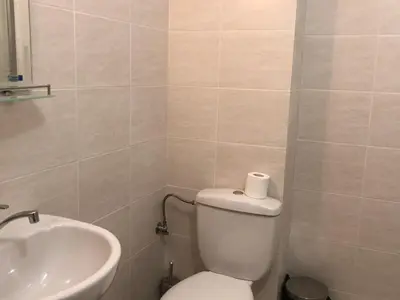 a bathroom with a toilet and a sink at Apartamenti Eli in Pomorie