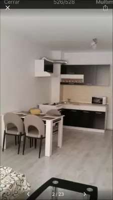 a kitchen with a table and chairs in a room at Apartamenti Eli in Pomorie