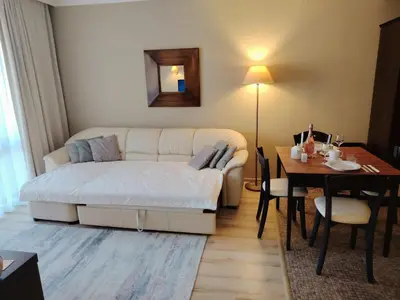 a living room with a couch and a table at Apartment in Hotel Royal Beach 5 Pool View in Sunny Beach