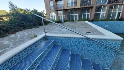 an outdoor staircase with blue tiles in a building at Sanny view South- Студия Мир авангарда in Sunny Beach