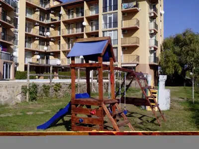a playground in front of a large apartment building at Sanny view South- Студия Мир авангарда in Sunny Beach