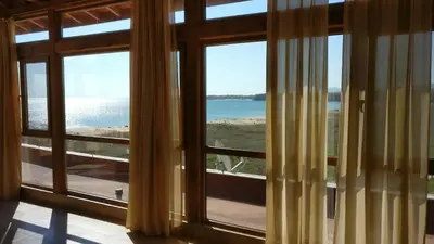 a room with large windows looking out at the ocean at Club Priz in Primorsko