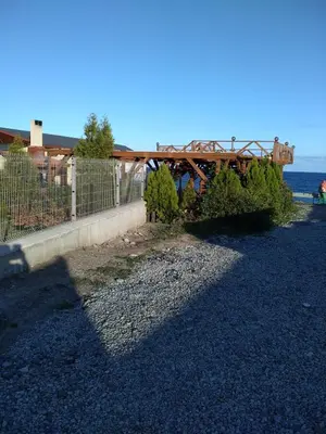 a wooden bridge over a road next to the ocean at Villa Gracia in Ravda