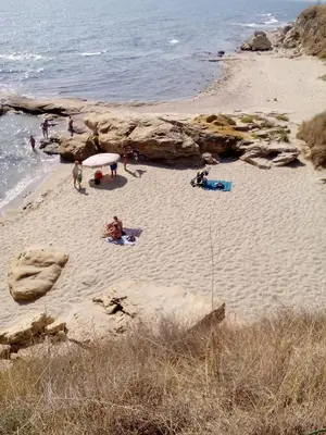 a group of people on a beach near the water at Villa Gracia in Ravda
