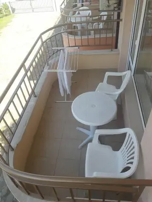 a balcony with a table and two chairs on a ship at Hotel Black Sea - Breakfast, Pool & Free Parking in Obzor