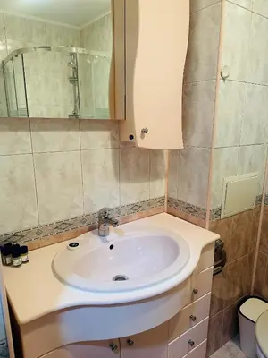 a bathroom with a sink and a mirror at Lux Apartment Sisi in Burgas City