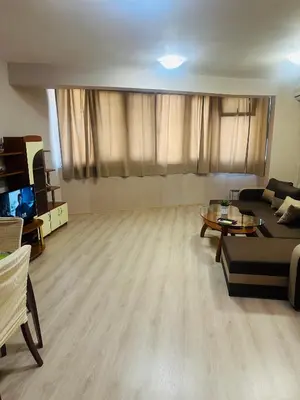 a living room with a couch and a table at Lux Apartment Sisi in Burgas City