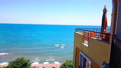 a view of the ocean from the balcony of a building at AKB Apartment Sea View in Aheloy