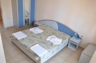 a hospital room with a bed with towels on it at Hotel BelleVille in Sunny Beach