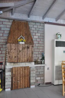 a garage with a wooden door and a brick wall at Hotel BelleVille in Sunny Beach
