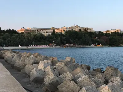 a retaining wall next to a body of water at Hotel Capri in Nesebar