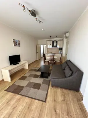 a living room with a couch and a dining room at Hotel Capri in Nesebar