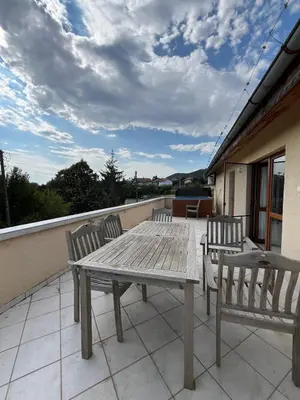 a wooden table and two chairs on a balcony at Villa Tunley in Razvalini Balchikioy