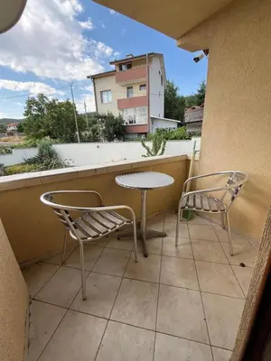 a patio with two chairs and a table on a balcony at Villa Tunley in Razvalini Balchikioy