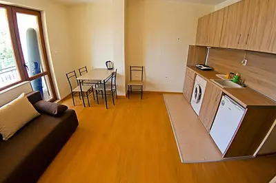a kitchen and living room with a couch and a table at Galata in Varna City