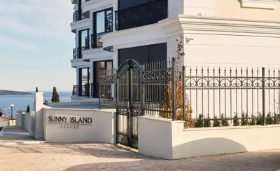 a large white building with a sign that reads sunny board hotel at Morning Star Deluxe in Chernomorets