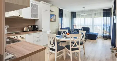 a kitchen and living room with a table and chairs at Morning Star Deluxe in Chernomorets