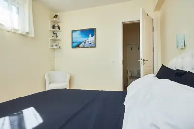a bedroom with a bed and a chair in it at Morning Star Deluxe in Chernomorets