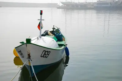 a boat is docked in the water on the water at Ivanovi Apartments in Burgas City