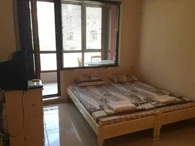 a bed sitting in a room with a window at Apartment Martin Beach in Pomorie