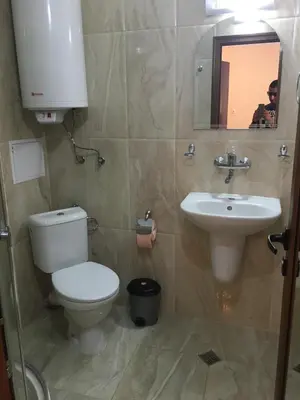 a bathroom with a toilet and a sink at Apartment Martin Beach in Pomorie