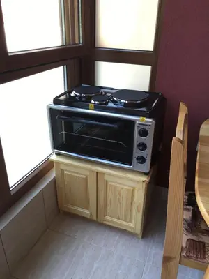 a microwave oven sitting on top of a wooden cabinet at Apartment Martin Beach in Pomorie