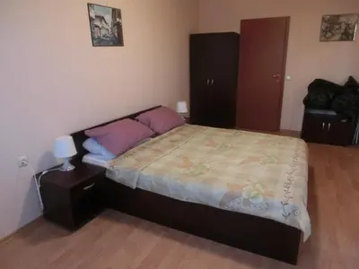 a bedroom with a bed and a nightstand with a bed sidx sidx sidx sidx at Sea View Crown apartment on complex with pools and beach, Sveti Vlas in Sveti Vlas