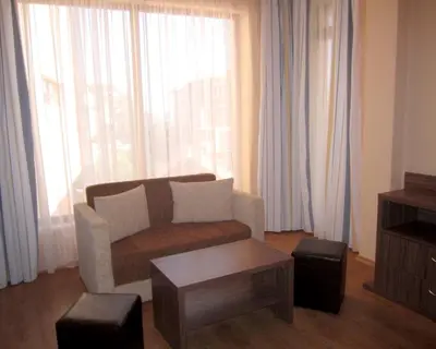 a living room with a couch and a coffee table at Hotel COOP Central in Obzor