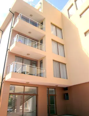 a facade of a building with a balcony at Hotel COOP Central in Obzor