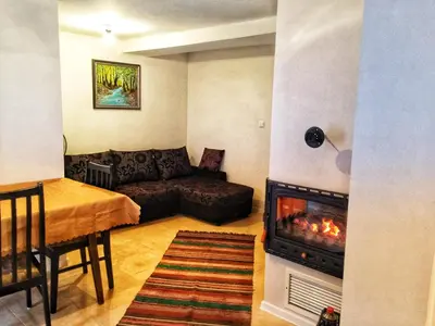 a living room with a couch and a fireplace at Sunset House in Varna City