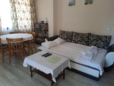 a living room with a couch and a table at White home-apartament in Burgas City
