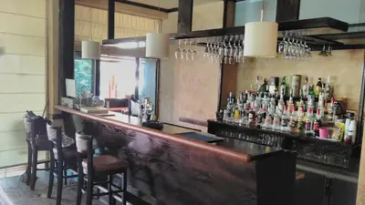 a bar with a bunch of bottles of alcohol at Golden Dreams Apartment in Sunny Beach