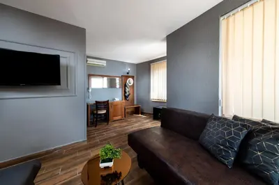 a living room with a couch and a table at Petrov Family Hotel in Nesebar
