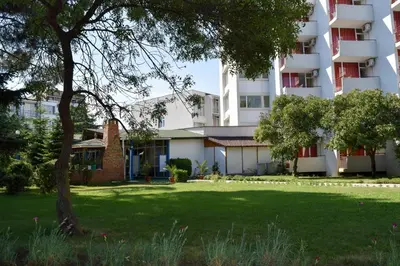 a green yard in front of a building at Balaton Hotel in Sunny Beach