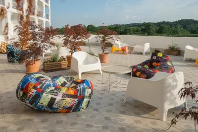 a group of chairs and tables on a patio at Sunrise Blue Magic Resort - All Inclusive in Obzor