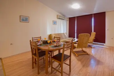 a dining room with a table and chairs at Green Fort Private Apartments in Sunny Beach
