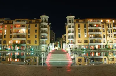 a stairway leading to a pool of water in front of buildings at Royal Sun Apartments in Sunny Beach