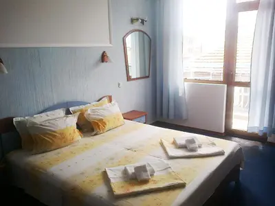 a bedroom with a bed with two towels on it at Aquamarine in Sozopol