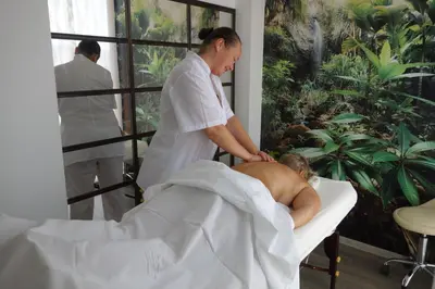 a man getting a massage from a man in a chair at Aquamarine in Sozopol