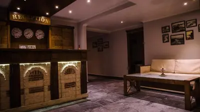 a living room with a couch and a fireplace at Prince Cyril Hotel in Nesebar